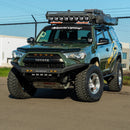 Green Toyota 4Runner with additional lights and an RTS “Rugged Terrain Series” Front Winch Bumper (2014-2024 models) on a paved surface.