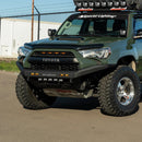 Front angle view of a Green Toyota 4Runner with additional lights and an RTS “Rugged Terrain Series” Front Winch Bumper (2014-2024 models) on a paved surface.