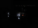 Front end of a Hummer H2 with white LED headlight and fog light halos.