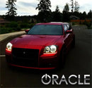 Front end of a Dodge Magnum with white LED headlight halo rings installed.