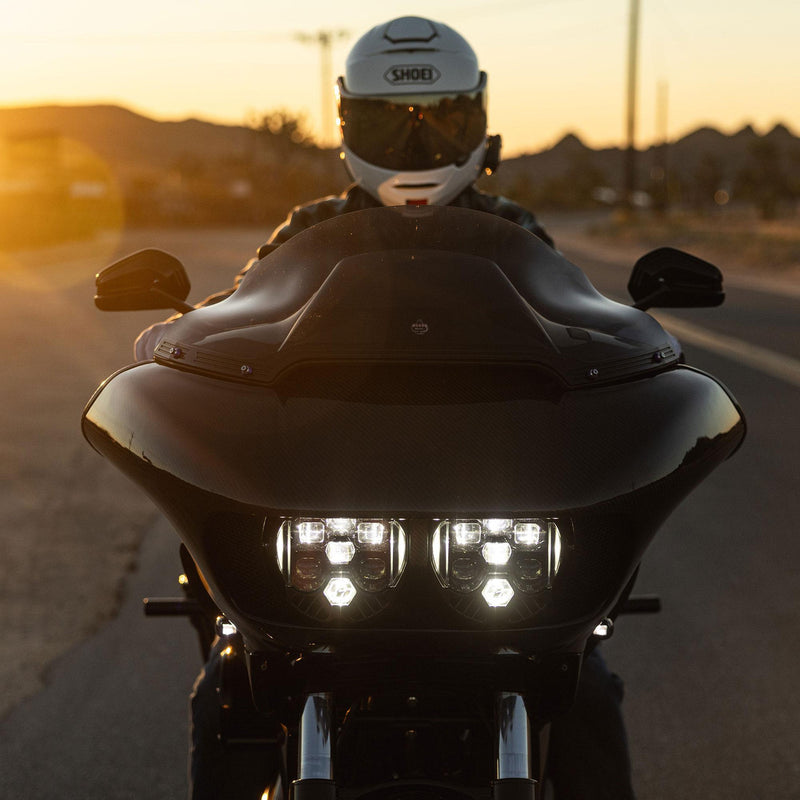 Motorcyclist on a black motorcycle with sunset in the background