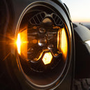 Close-up of a car headlight with a blurred background