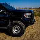 Black pickup truck on a dirt road with a clear blue sky