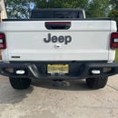 Rear view of a white Jeep Gladiator with Rear Bumper LED Reverse Lights installed.