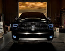 Front end of a RAM 1500 Sport with white headlight and fog light halos.
