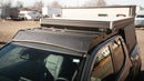 Car with a roof rack on a sunny day, parked outdoors.