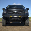 Black Toyota truck with large tires on a clear day