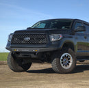 Black Toyota Tundra 2014-2021 models on a dirt road with a clear blue sky, equipped with a RTS “Rugged Terrain Series” Front Winch Bumper