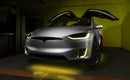 Silver Tesla Model X with yellow headlight and fog light DRLs.