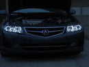 Front end of an Acura TSX with white LED headlight halo rings installed.