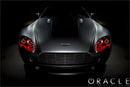 Front view of an Aston Martin Vantage with red LED headlight halo rings installed.