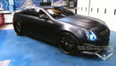 Three quarters view of a Cadillac CTS-V Coupe with white LED headlight halo rings installed.