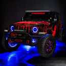 Three quarters view of a red Jeep Wrangler JL, with ColorSHIFT Oculus Headlights, and blue halo rings.