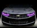 Front end of a Chevrolet Camaro with pink headlight DRLs.