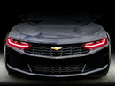 Front end of a Chevrolet Camaro with red headlight DRLs.