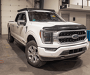 White Ford F150 truck with black prinsu pro roof rack in a warehouse setting