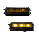 Two black rectangular FORM Lighting LED Fog lights for the Toyota Tacoma with yellow illumination on a white background