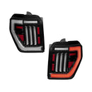 Pair of car tail lights with black and red design on a white background
