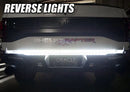 Rear view of a Ford Raptor with 60" Double Row LED Truck Tailgate Light Bar installed and reverse lights on.