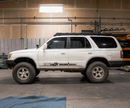 White 4Runner with '4x4 Offroad' decal in a warehouse setting