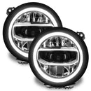 Jeep Wrangler JL headlights with white DRLs.